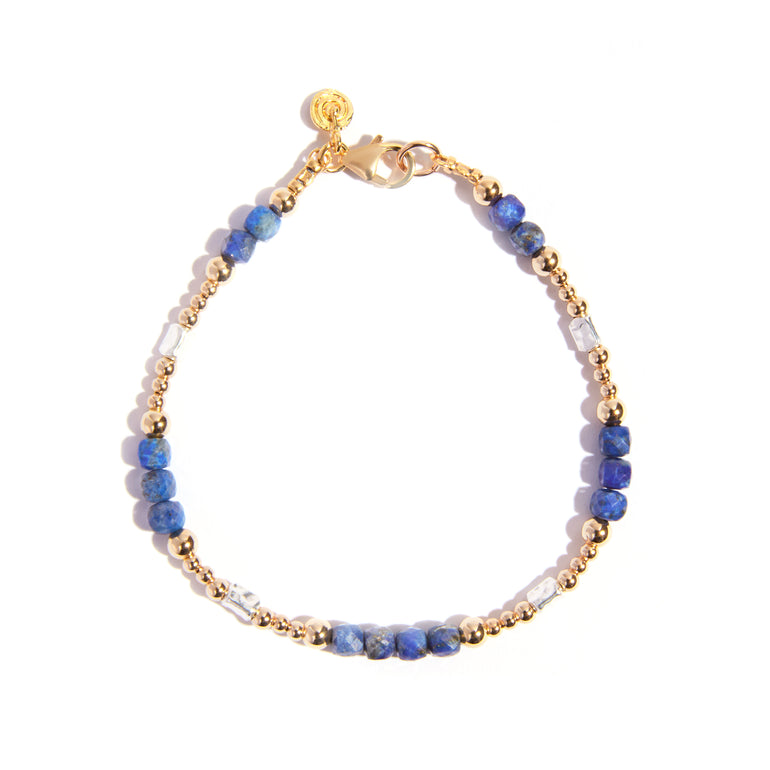 Elevate your style with our stunning Lapis Lazuli bracelet delicately set in silver and gold-filled accents. Featuring a captivating cut this 7.5-inch bracelet adds a touch of elegance to any ensemble.