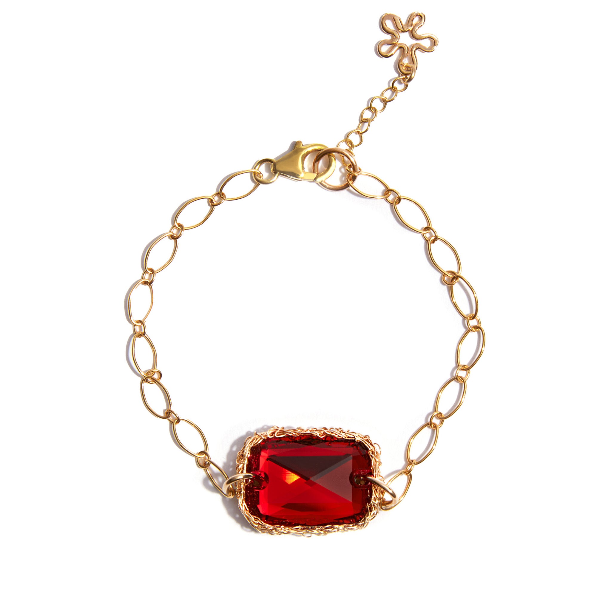 Our classic crochet gold technique is adapted for this gorgeous statement bracelet. A Siam Red gem sits on a large linked chain bracelet complete with an adjustable chain with a flower charm.