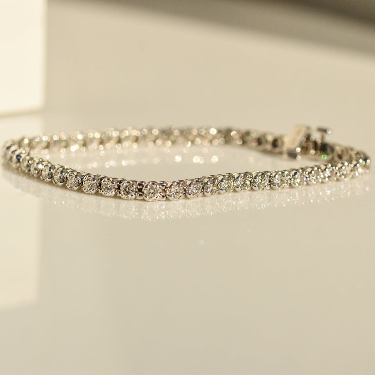 Exquisite 14ct White Gold Diamond Tennis Bracelet adorned with natural diamonds, crafted with precision. Crafted in 14 carat white gold. Features a total of 7.15 carats of diamonds. Weighs 13.73 grams