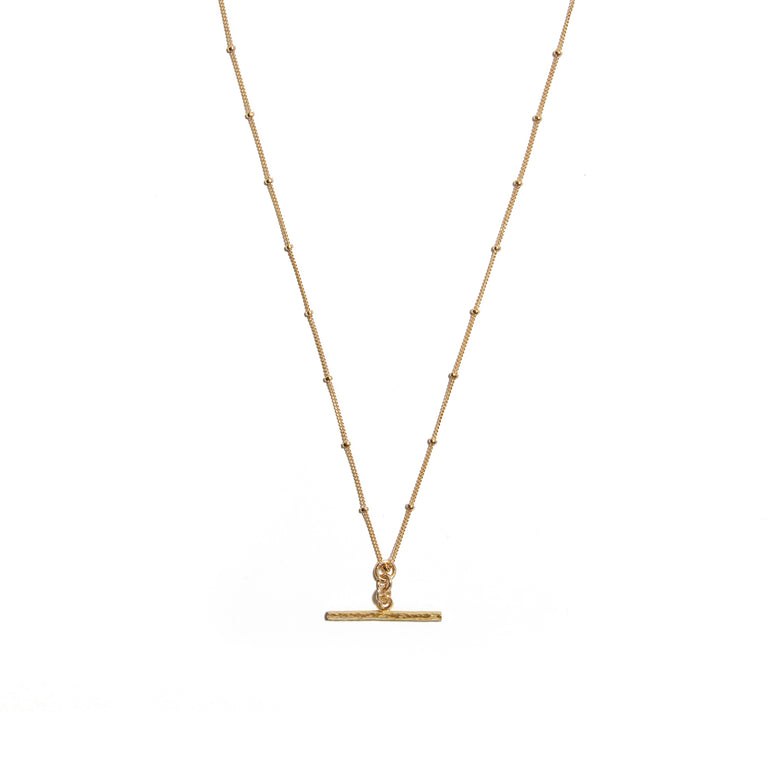 Enhance your style with the T-Bar on cut ball chain necklace made from 14ct Gold-fill. This chic accessory features a sleek T-Bar pendant suspended from a stylish cut ball chain, perfect for adding a touch of sophistication to any outfit. A versatile piece for everyday wear.