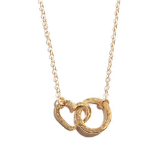 Photo of a double heart and circle necklace made from 14 carat gold fill. A charming accesory ideal for gifting or adding a touch of elegance to any outfit.