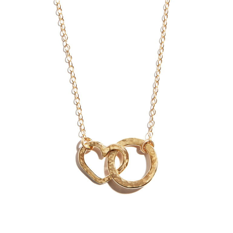 Photo of a double heart and circle necklace made from 14 carat gold fill. A charming accesory ideal for gifting or adding a touch of elegance to any outfit.