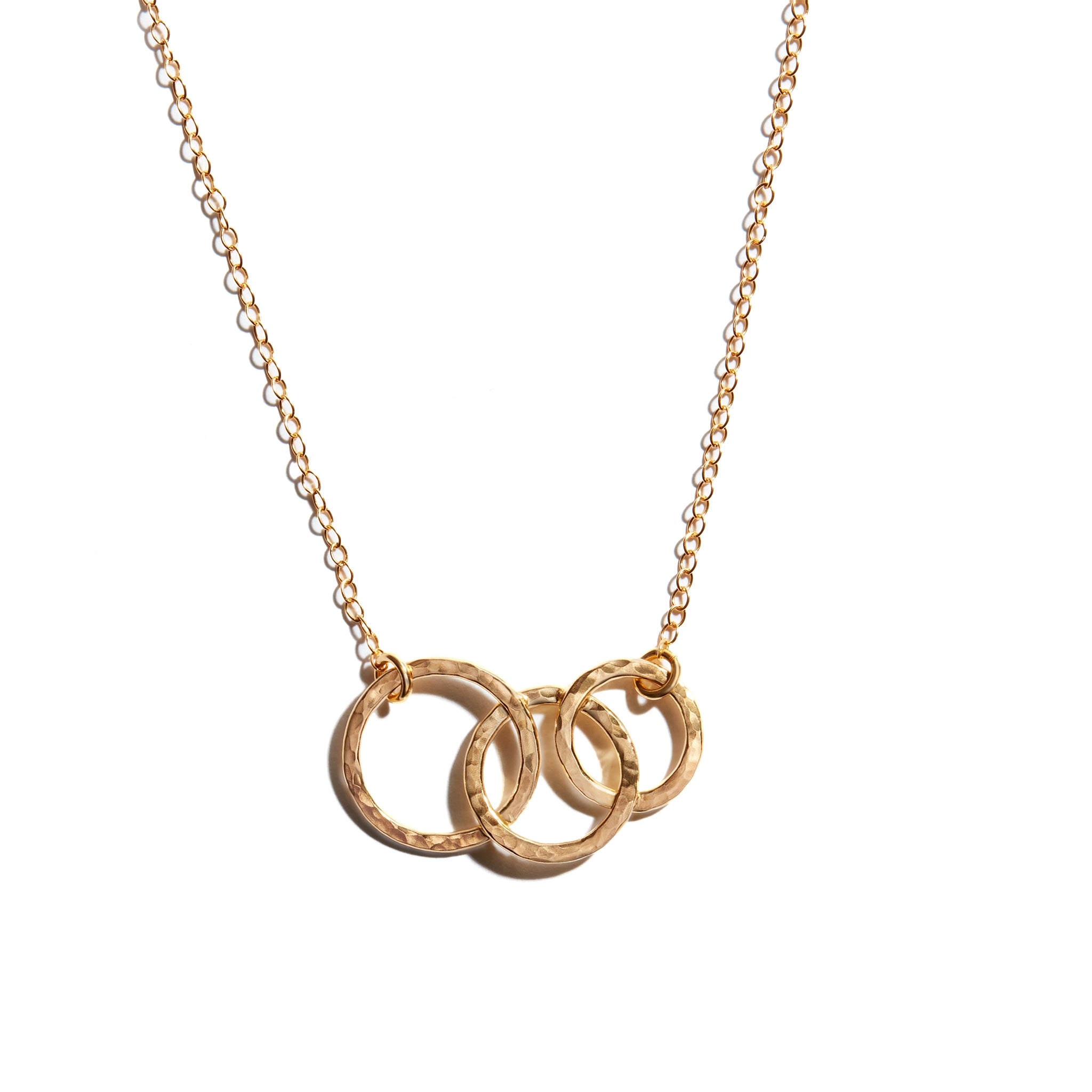 Close-up photo of triple circle necklace crafted from 14 carat gold fill. Perfect for adding elegance to any outfit.