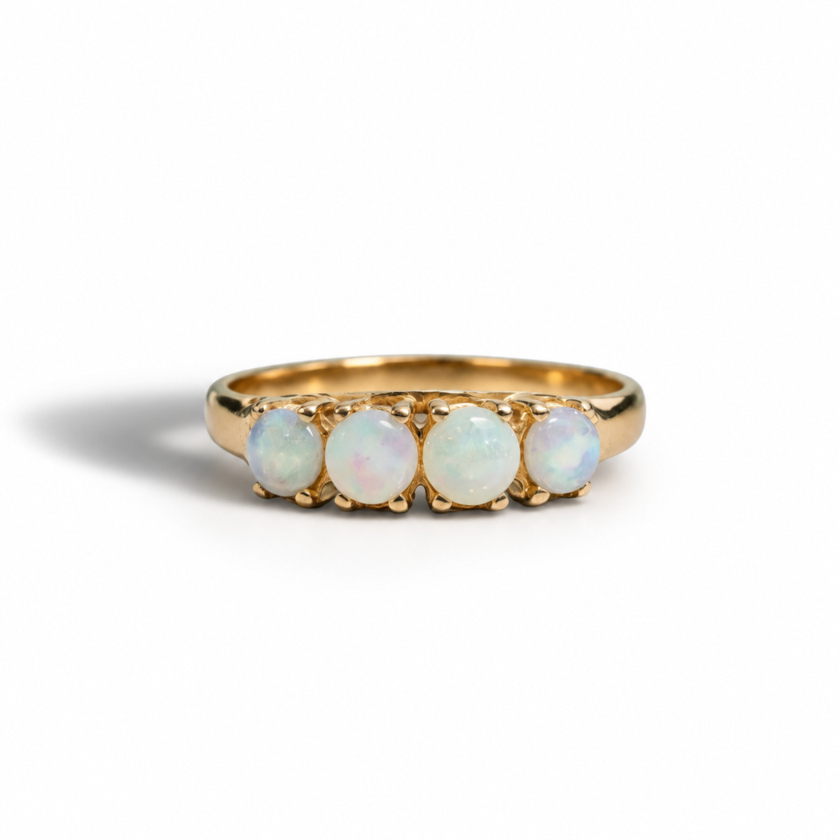 A luminous opal ring crafted in rich 14ct yellow gold. Four softly glowing opals sit in a classic claw setting, each stone showing delicate flashes of pastel colour that shift beautifully with the light.

The smooth gold band keeps the focus on the opals while giving the ring a timeless, understated elegance. This ring is a size R, with resizing available depending on suitability.