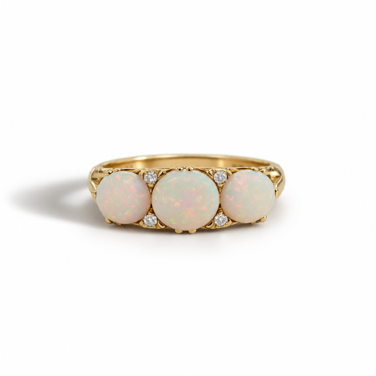 A striking antique ring crafted in 18ct gold, set with three generously sized opals glowing with soft flashes of green, peach and blue. Between them, delicate diamonds add refined sparkle, creating a beautiful contrast against the warmth of the gold.

Bold in scale yet beautifully balanced, this is a statement piece with true character — the kind of ring that doesn’t whisper, it speaks. A timeless antique design with presence, depth and undeniable charm.

Available in size M. Resizing may be possible upon r