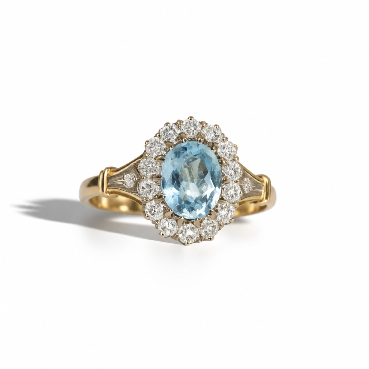 Vintage yellow gold ring featuring an oval blue gemstone surrounded by a halo of round diamonds, with diamond-set detailed shoulders.
