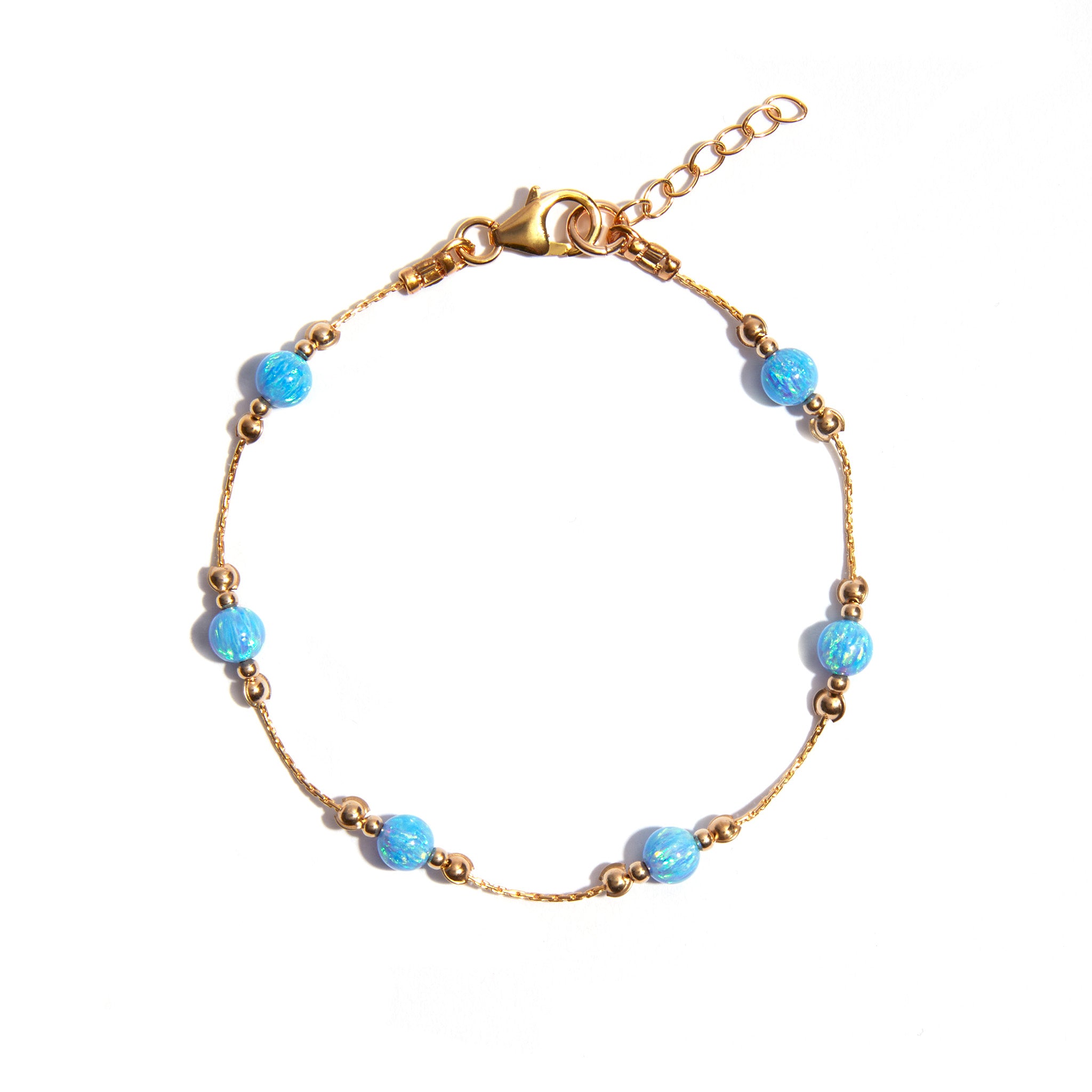This beautiful blue opal bracelet is crafted with a stunning lab blue opal pendant strung on an 7 inch 14ct gold filled chain. It is perfect for a night out or for day to day wear and is sure to accent your wardrobe in style.