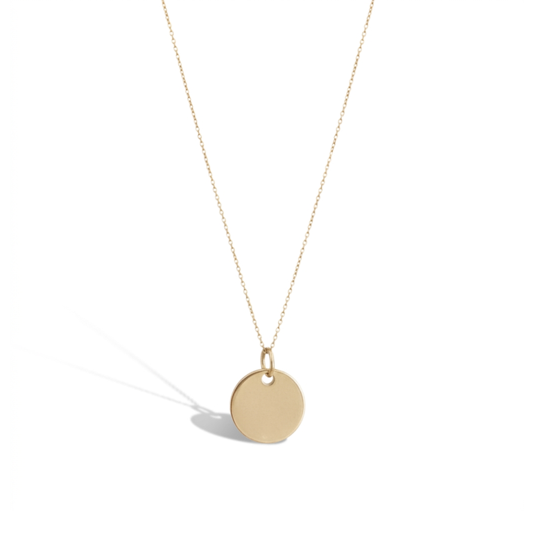 Gold necklace with a round pendant on a white background