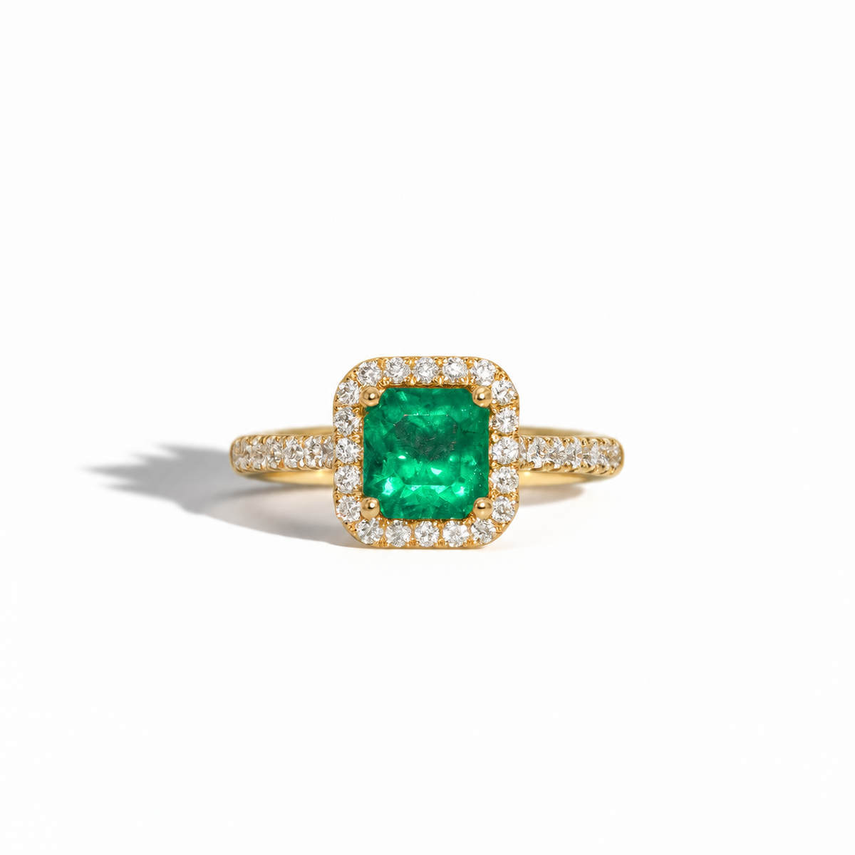 Yellow gold emerald and diamond halo ring with square-cut green emerald and pavé diamond band
