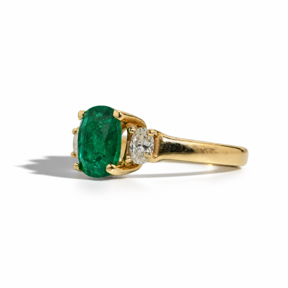14 carat yellow gold, a vivid 1.74 carat emerald takes centre stage