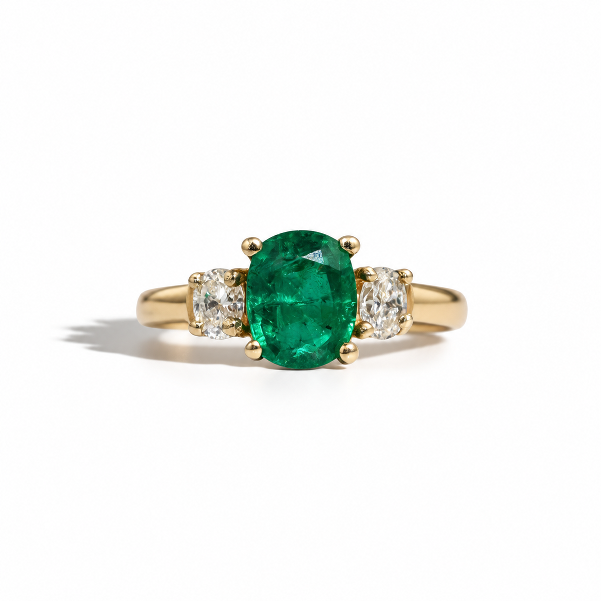 14 carat yellow gold, a vivid 1.74 carat emerald takes centre stage