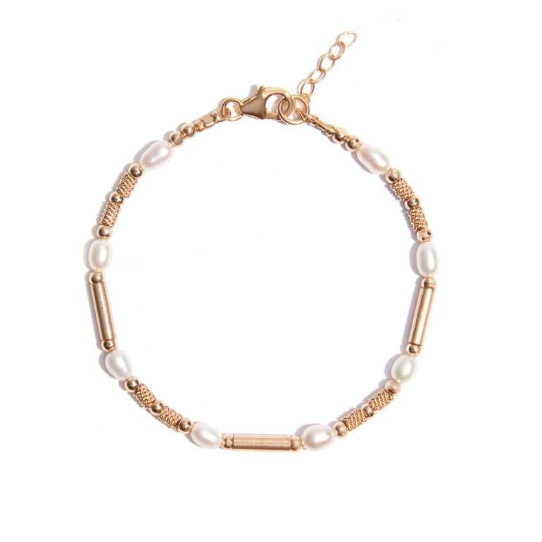Our 'Golden Glow' pearl bracelet is intricately crafted with pearls and features a chain made of 14 carat gold filled, adding a radiant shine and durable quality. It's an elegant and sophisticated piece that adds a touch of luxury to any outfit.