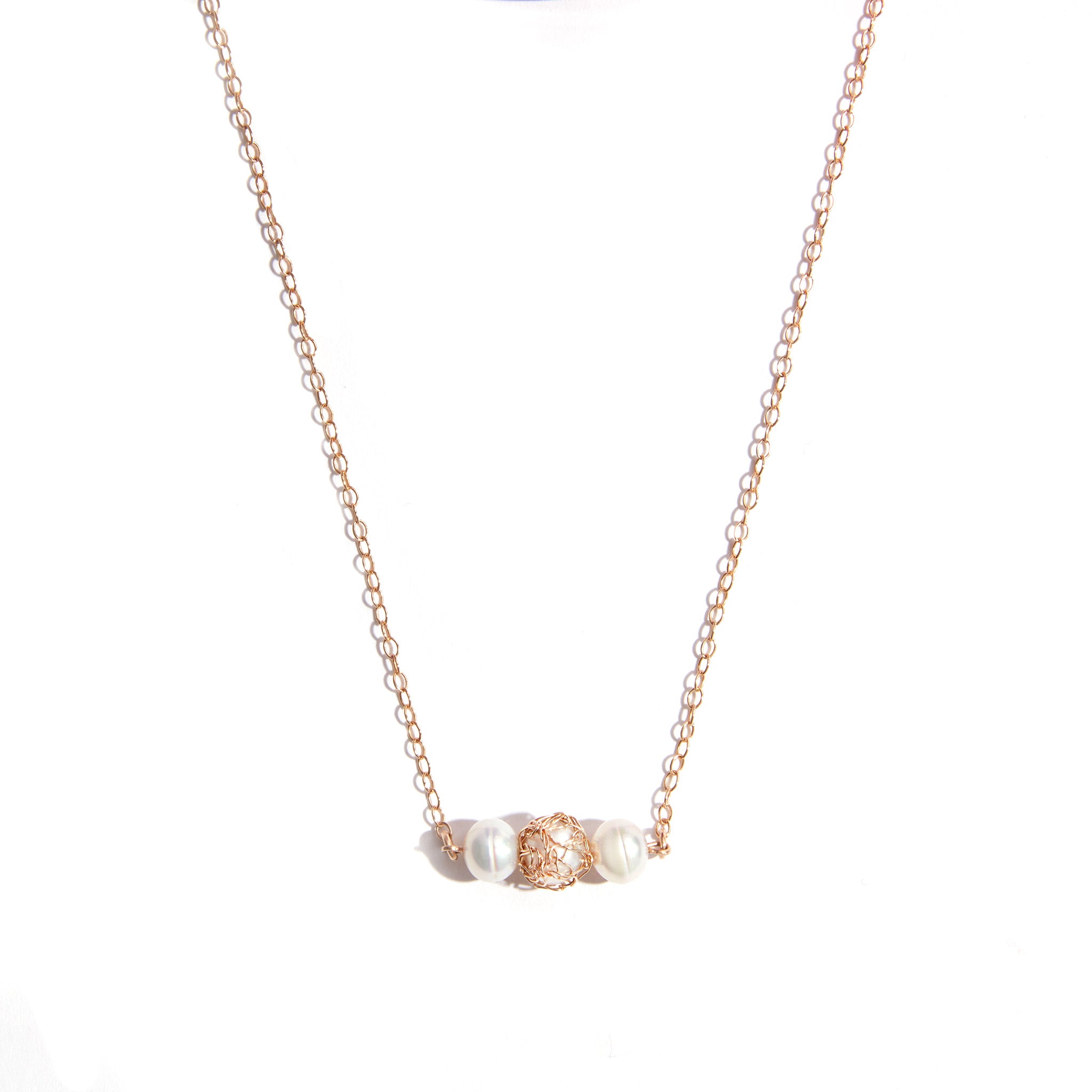 Gold Filled Pearl Knitted Necklace featuring three lustrous 6mm pearls. Crafted with high-quality gold-filled material for durability and long-lasting shine. Central detail highlights a hand-knitted pearl, complemented by additional pearls and gemstones for an extra touch of allure.