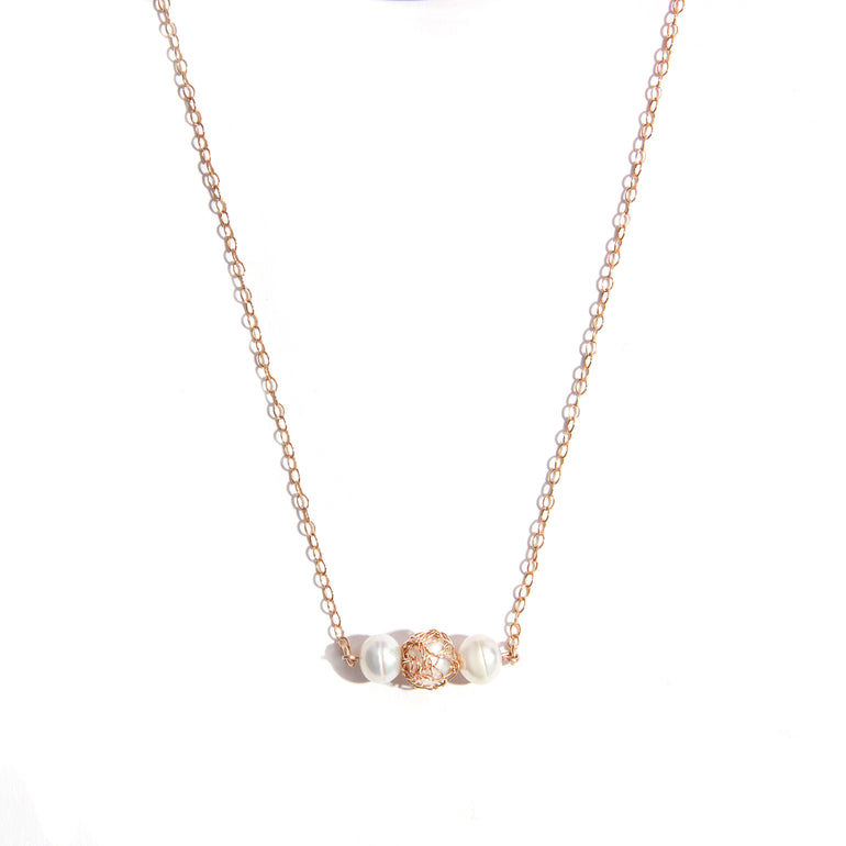 Gold Filled Pearl Knitted Necklace featuring three lustrous 6mm pearls. Crafted with high-quality gold-filled material for durability and long-lasting shine. Central detail highlights a hand-knitted pearl, complemented by additional pearls and gemstones for an extra touch of allure.