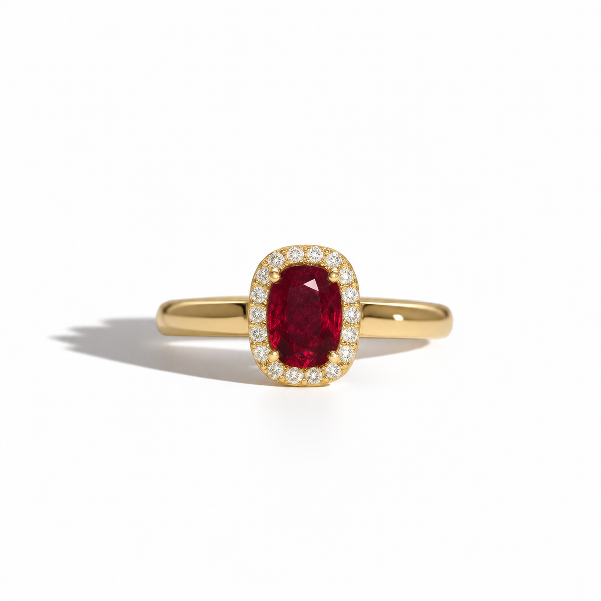Yellow gold ruby and diamond halo ring with an oval-cut red ruby centre stone surrounded by round brilliant diamonds