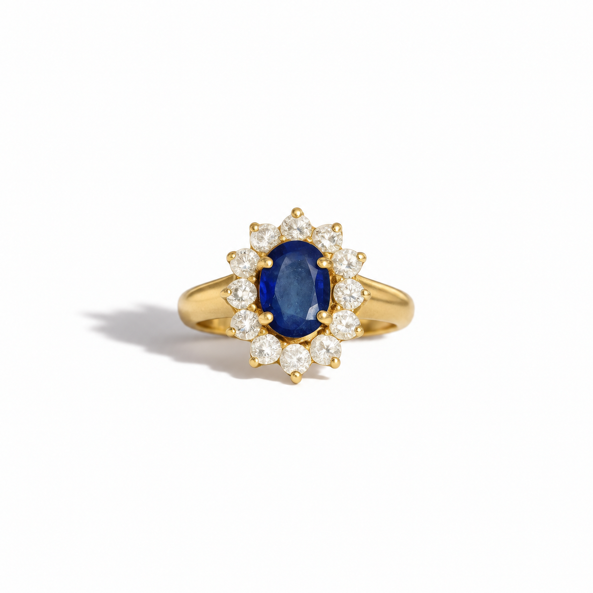 Vintage yellow gold oval blue sapphire and diamond halo ring with round brilliant cut diamonds