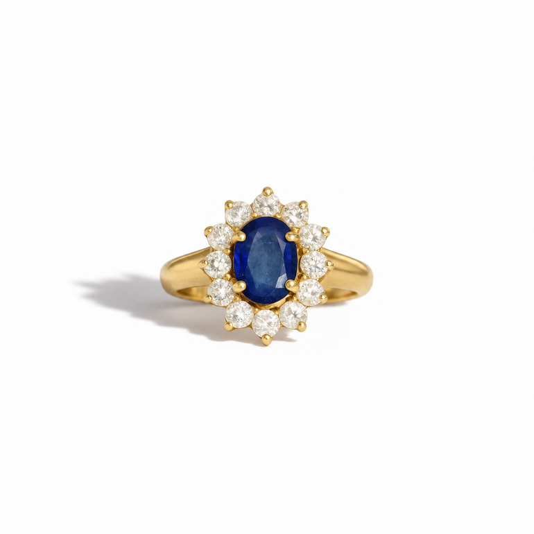 Vintage yellow gold oval blue sapphire and diamond halo ring with round brilliant cut diamonds