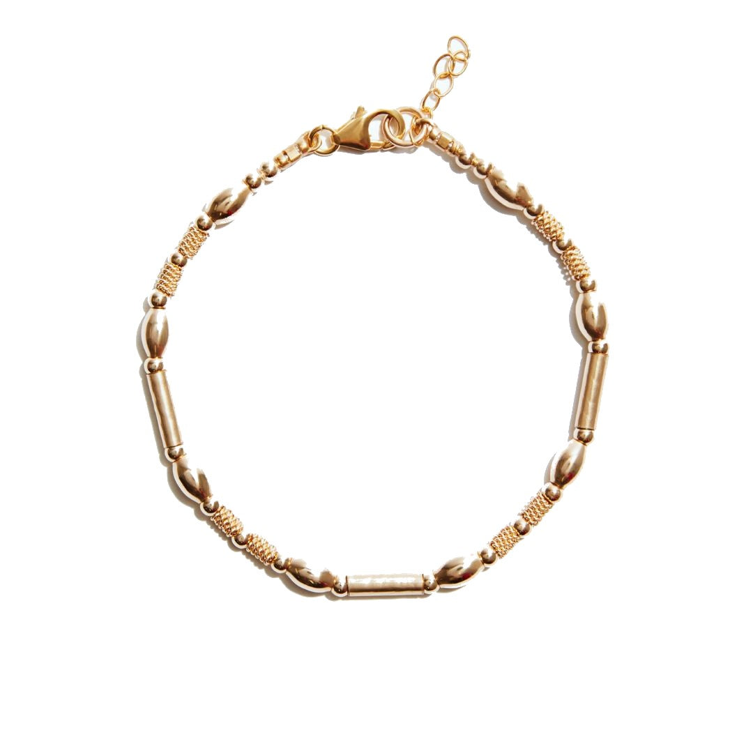Introducing the Seoidin Yellow Gold Bracelet, a true masterpiece of elegance. This exquisite bracelet features an array of golden beads in various sizes and textures, meticulously crafted to create a stunning visual and tactile experience. Adorn your wrist with this unique piece that effortlessly combines style and sophistication, making a bold statement wherever you go.