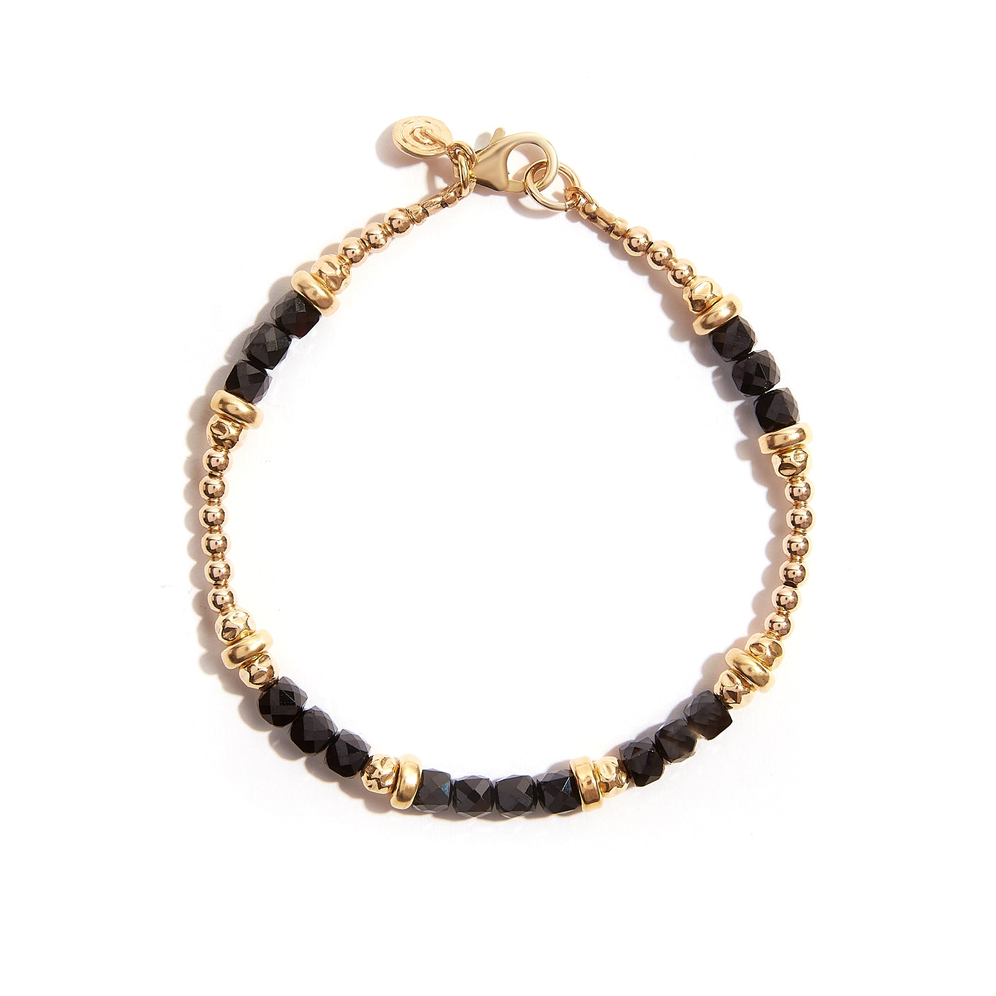 Introducing our mesmerizing Sparkling Spinel Faceted Bracelet, a stunning fusion of black and gold. This exquisite piece exudes elegance and sophistication, with its captivating contrast and brilliant sparkle. Material: Crafted from exquisite Gold Filled, ensuring durability and timeless elegance. Length: Measures 7 inches, offering a comfortable fit for most wrists.