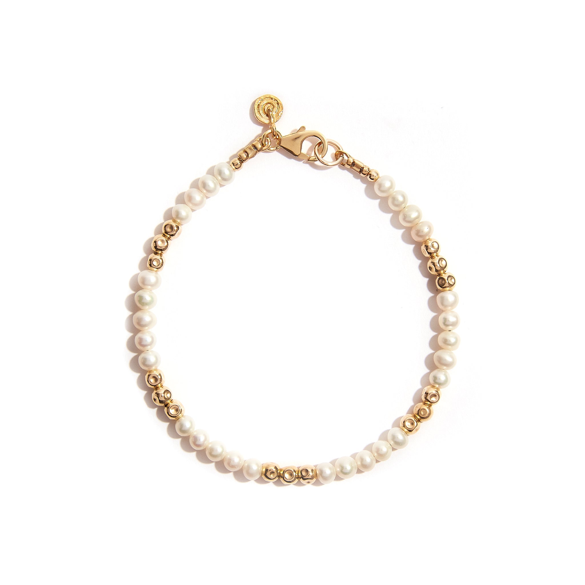 Introducing our Pearl Essence Bracelet, a timeless blend of elegance and sophistication. With a comfortable 7-inch length, it's the perfect accessory for any occasion. Elevate your style effortlessly with this classic piece. Material: 14ct Gold Filled. Length: Measures 7 inches, offering a comfortable fit for most wrists. Gemstone: Pearl