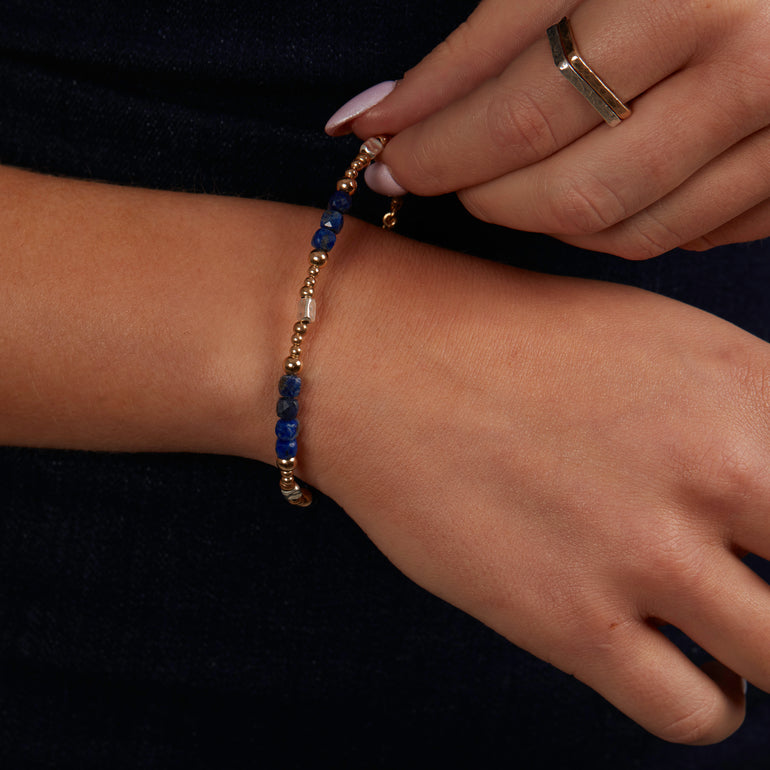 Elevate your style with our stunning Lapis Lazuli bracelet delicately set in silver and gold-filled accents. Featuring a captivating cut this 7.5-inch bracelet adds a touch of elegance to any ensemble.