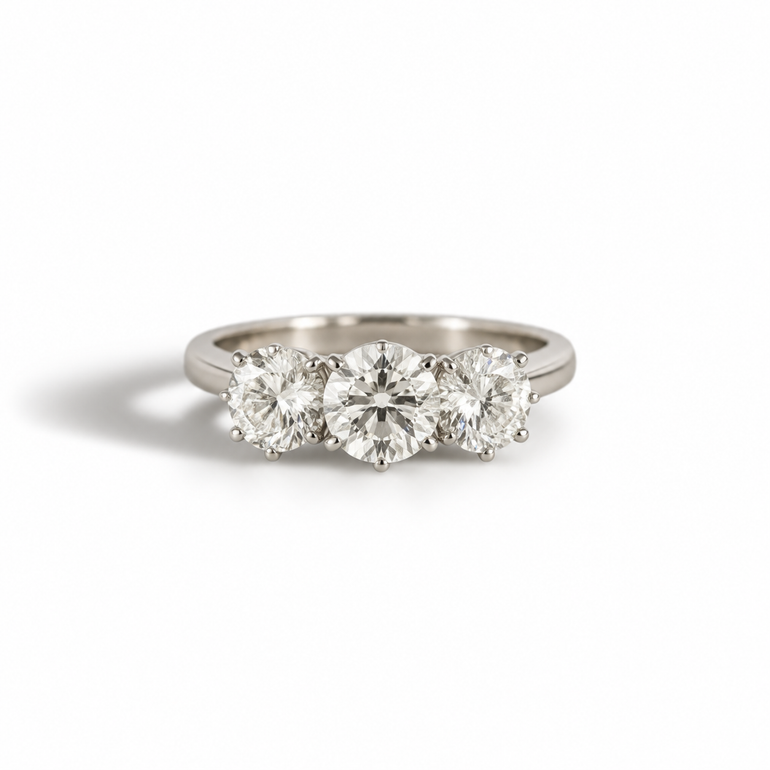 An exquisite trilogy ring crafted in&nbsp;platinum, showcasing 1.55ct of brilliant-cut diamonds. The three-stone design symbolizes the past, present, and future, making it a meaningful choice for engagements, anniversaries, or lifelong milestones. With its sleek platinum setting and dazzling sparkle, this timeless piece embodies both elegance and sophistication.