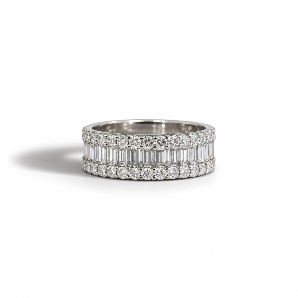 A sleek vintage diamond band with a refined, structured design that balances brilliance and symmetry beautifully.

Crafted in 14k white gold, this ring features a central row of baguette-cut diamonds, framed by two rows of round brilliant diamonds for added sparkle and depth. The layered effect creates a bold yet elegant silhouette, making it perfect as a statement band, stacking piece, or alternative wedding ring.

Understated but striking — this is effortless everyday luxury.

Key Details

14k White Gold
