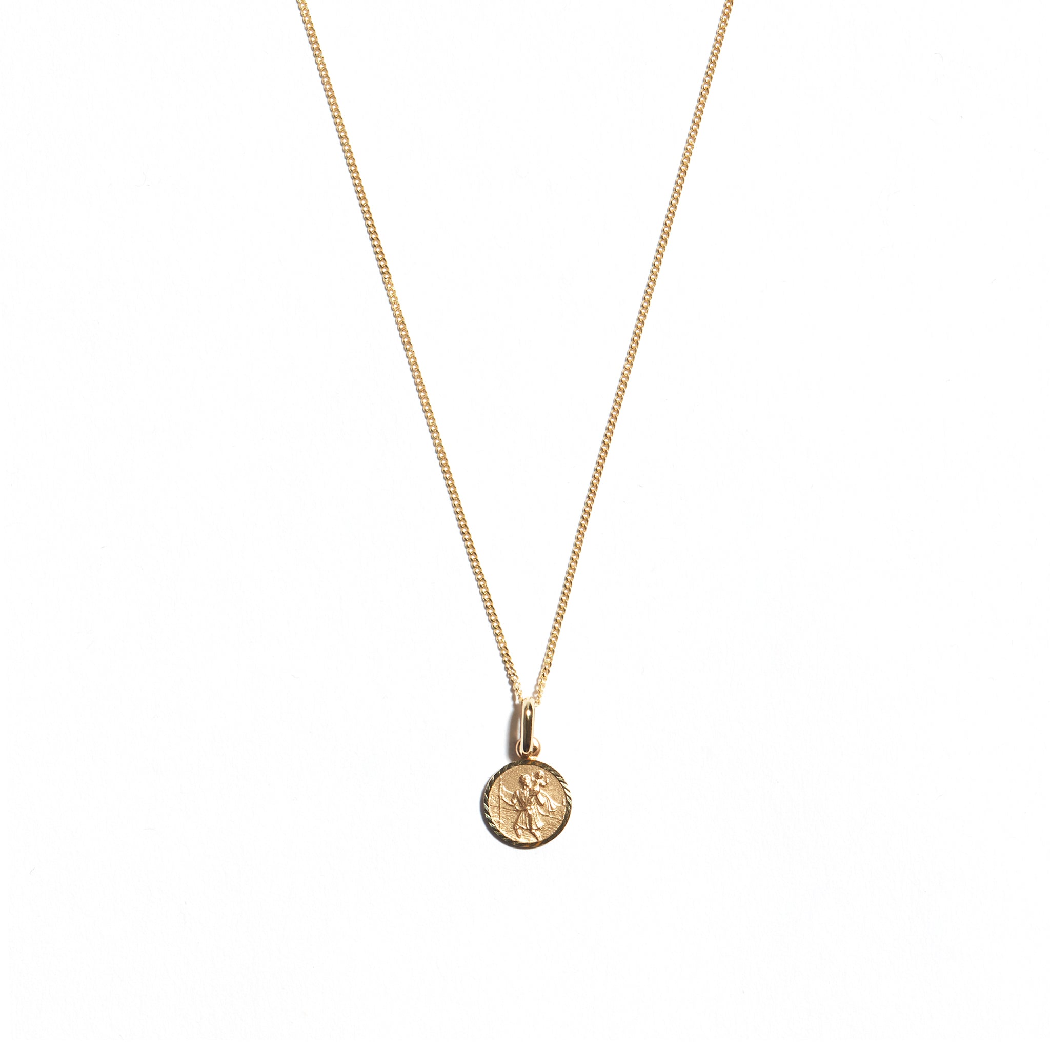 Elevate your look with the 9 carat yellow gold Small St Christopher Medal. This iconic accessory features a beautifully crafted medal depicting St Christopher, known for protection during travels. Perfect for adding a delicate touch of faith and style to your ensemble.