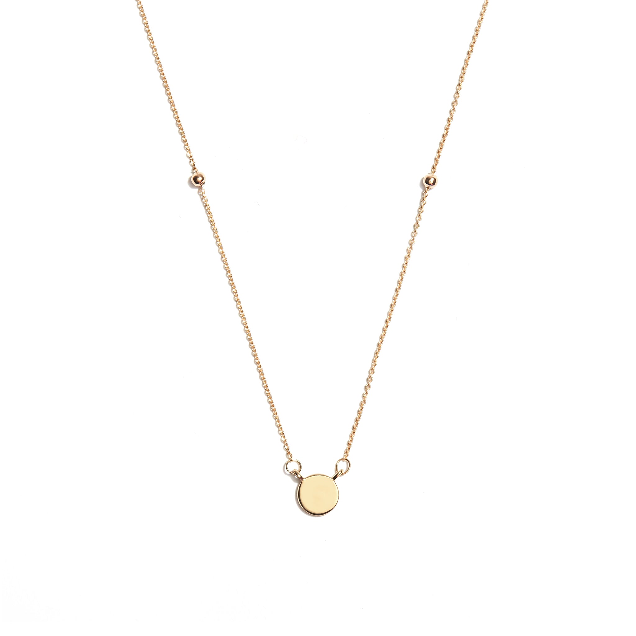 Add a touch of elegance to your ensemble with the 9 carat yellow gold disc & ball pendant. This stylish accessory features a sleek disc adorned with a dangling ball, perfect for adding a hint of glamour to any outfit. elevate your look with this versatile piece.