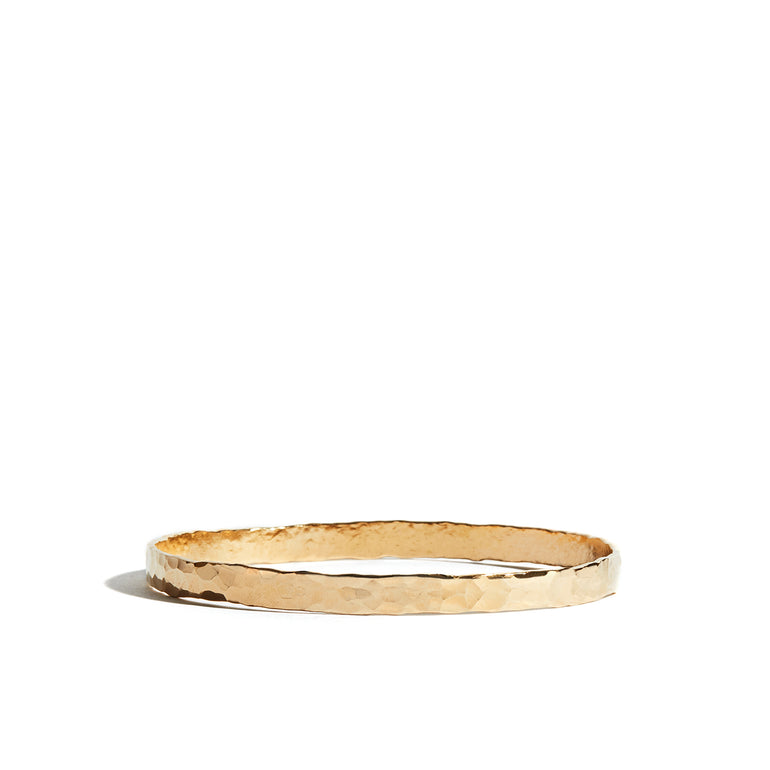 A timeless hand-hammered bangle crafted from 14ct gold fill, perfect for adding elegance to any wrist.