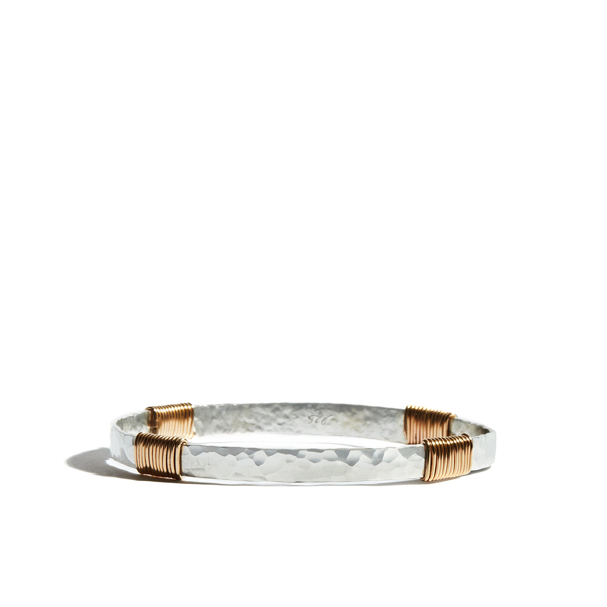 A stylish sterling silver bangle with wrap details made from 14ct gold fill, perfect for adding a touch of elegance to any look.