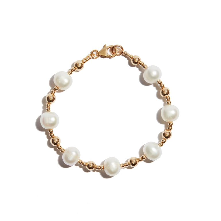 Our Pearl and Gold Bracelet features larger followed by smaller beads consecutively strung, and pearls to add just a little extra bit of elegance.