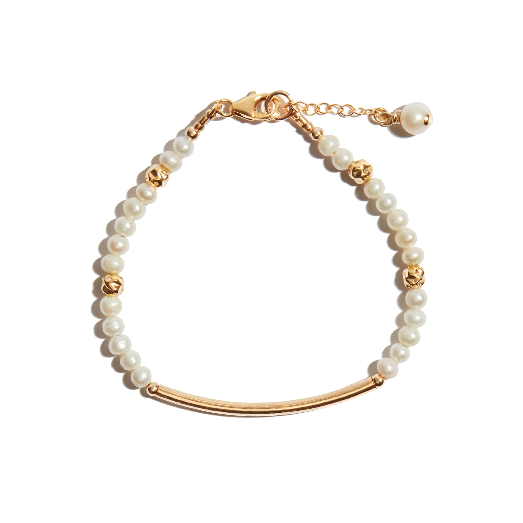 Our Pearl & Gold Bar Bracelet features a thin hammered gold bar, strung with delicate pearls. There is an adjustable chain at the clasp with a single pearl charm. Perfect on its own for a bridal look or simply to add a touch of elegance to your look every day. This bracelet's simple yet beautiful design makes it wonderfully versatile.