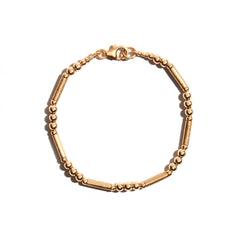 Photo of our Simple Gold Bracelet features consecutively strung beads and textured tube beads to create a delicate & simple gold bracelet that everyone will love.