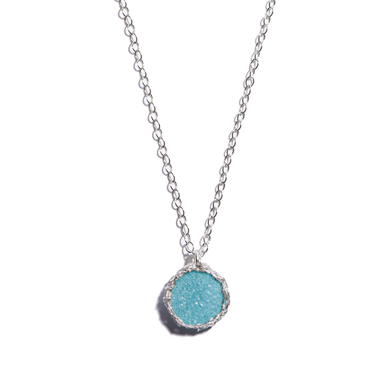 Elevate your style with the aqua silver hand crochet pendant. a must-have piece for those who appreciate artisanal craftsmanship.