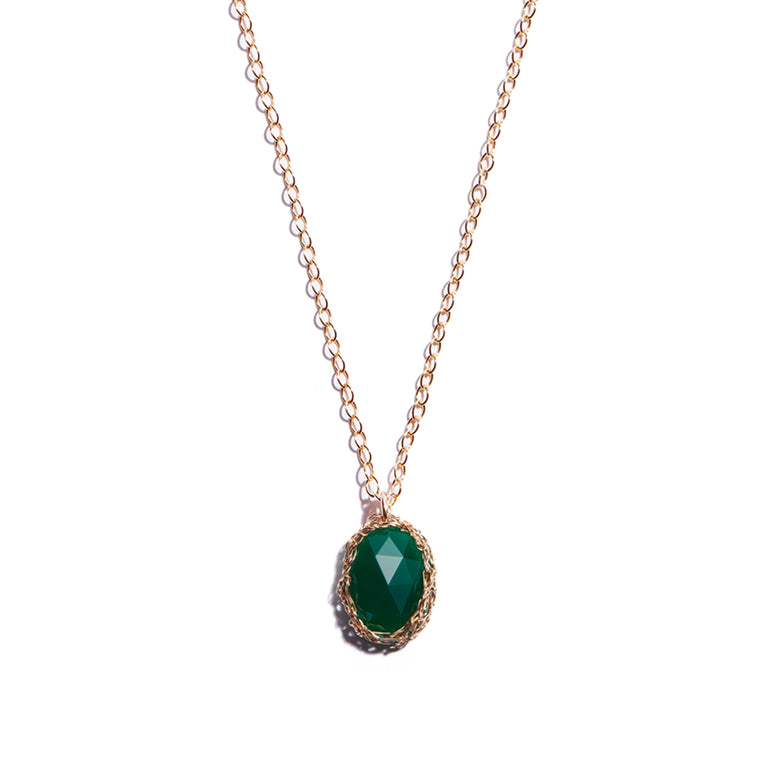 Close-up photo of an emerald glass crystal pendant, meticulously crafted from 14 carat gold-filled metal. This exquisite piece exudes elegance and charm, perfect for enhancing any ensemble.