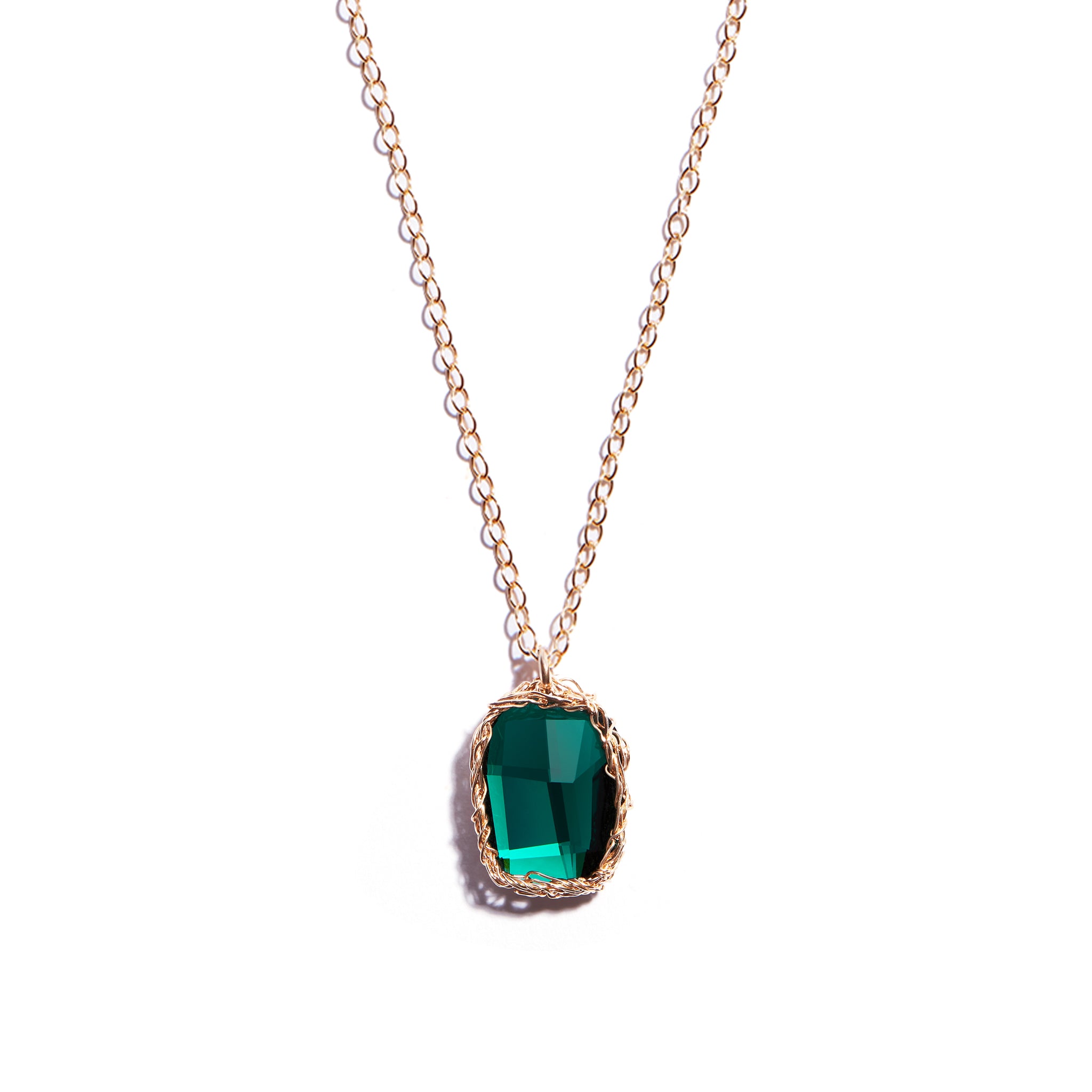 Vibrant emerald green crochet pendant crafted from 14 carat gold-filled metal, adorned with a sparkling swarovski emerald stone. This elegant Seoidin classic pendant is a stunning addition to any outfit and makes the perfect gift for someone special.