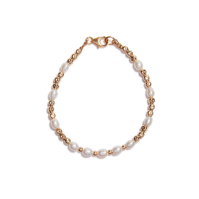 Our Pearl and Beaten Bead Bracelet features beaten beads consecutively strung with a collection of pearl beads throughout.
