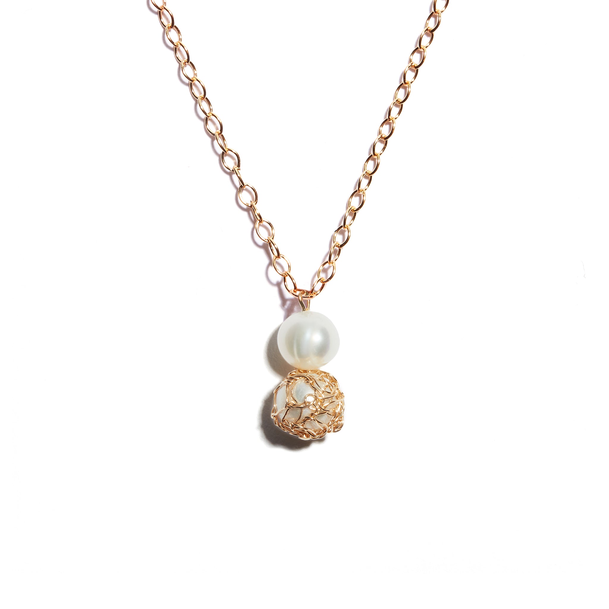 Exquisite double pearl pendant featuring crochet detailing on one pearl, crafted from high-quality 14 carat gold-fill, adding sophistication and uniqueness to your ensemble.