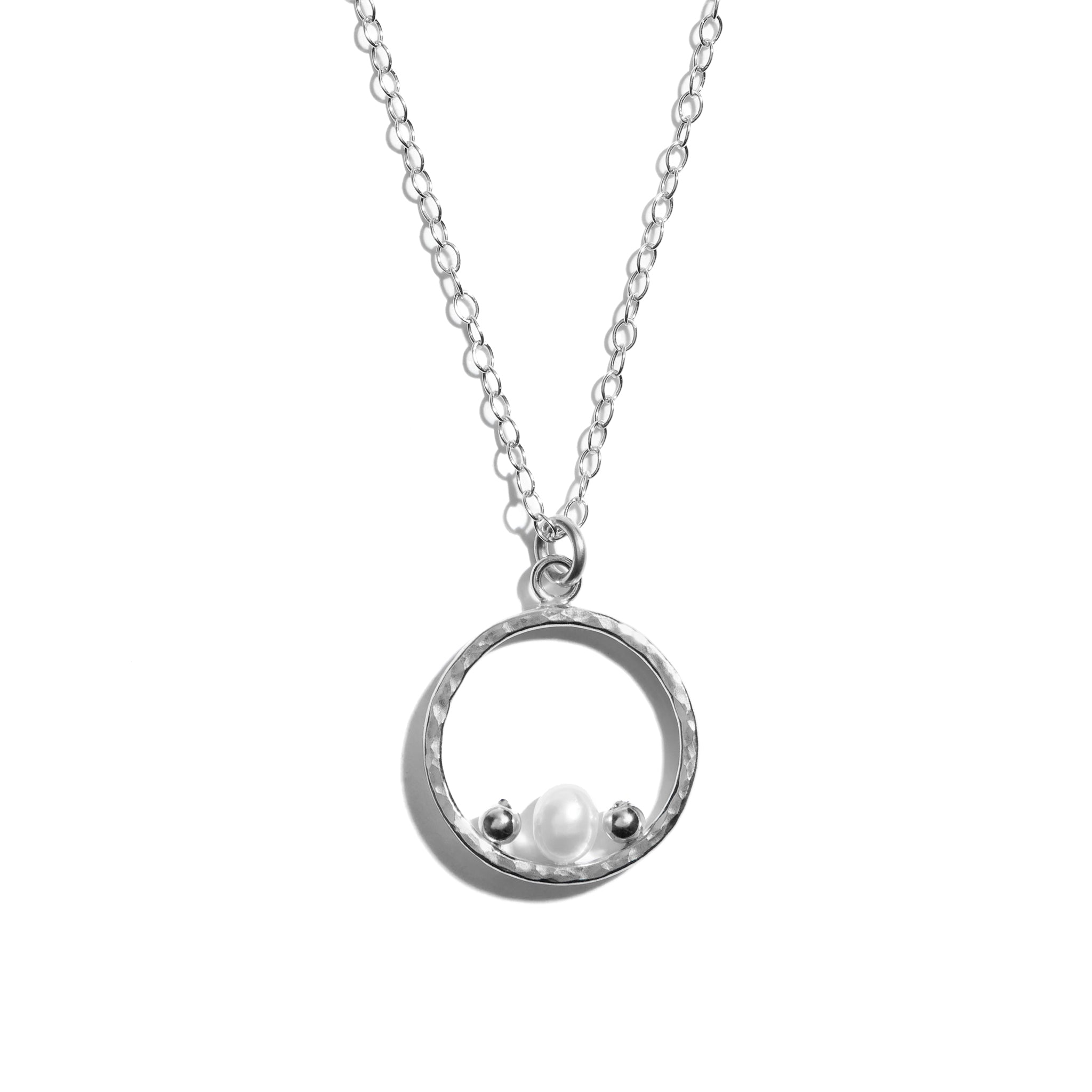 Photo of a luxurious silver pearl necklace crafted from sterling silver. The delicate pearls are elegantly arranged within the circular pendant, exuding timeless sophistication and charm.