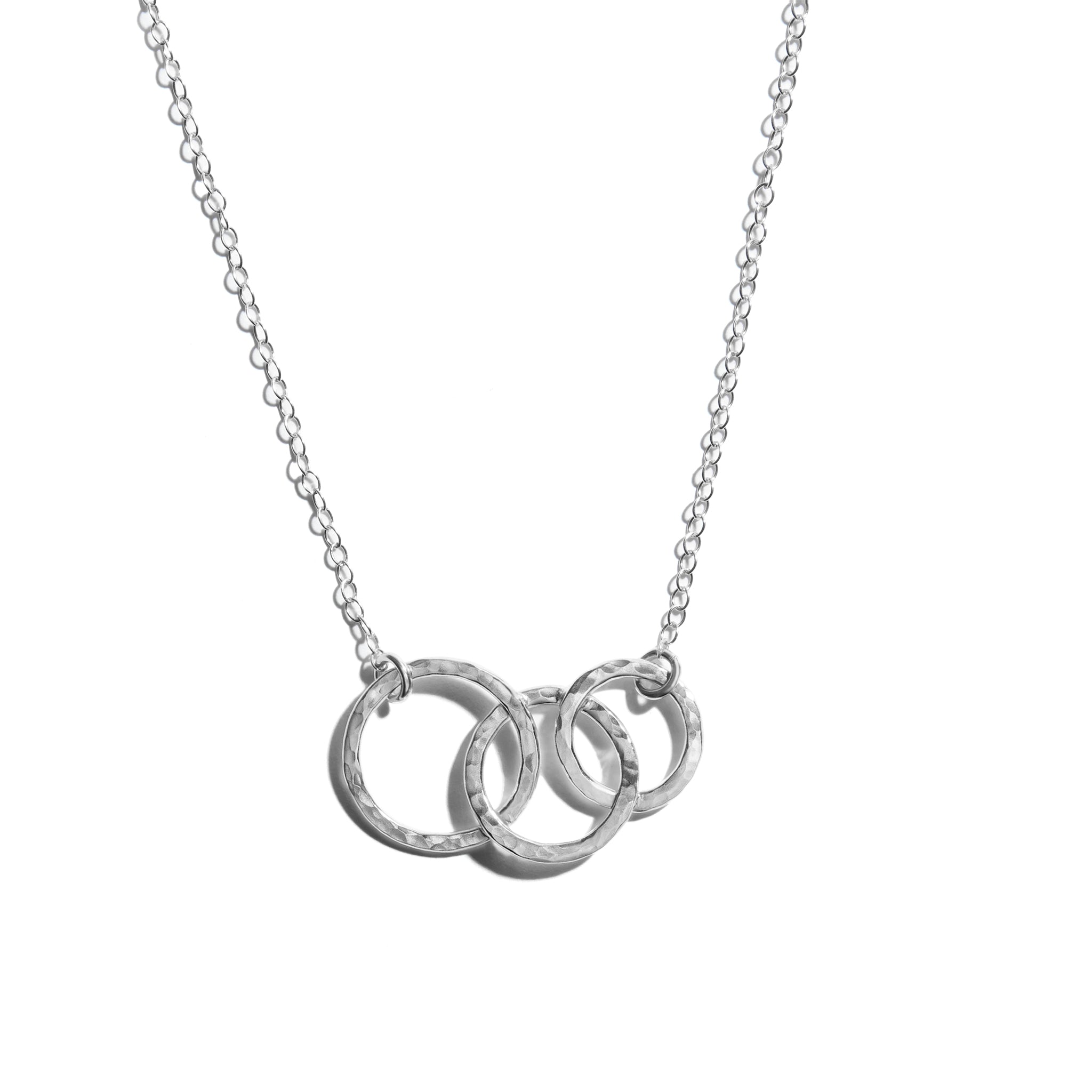 Close-up photo of triple circle necklace crafted from sterling silver. Perfect for adding elegance to any outfit.