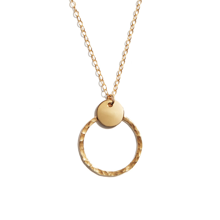 Close-up photo of a duo disk necklace crafted from 14 carat gold fill. Perfect for adding elegance to any outfit.