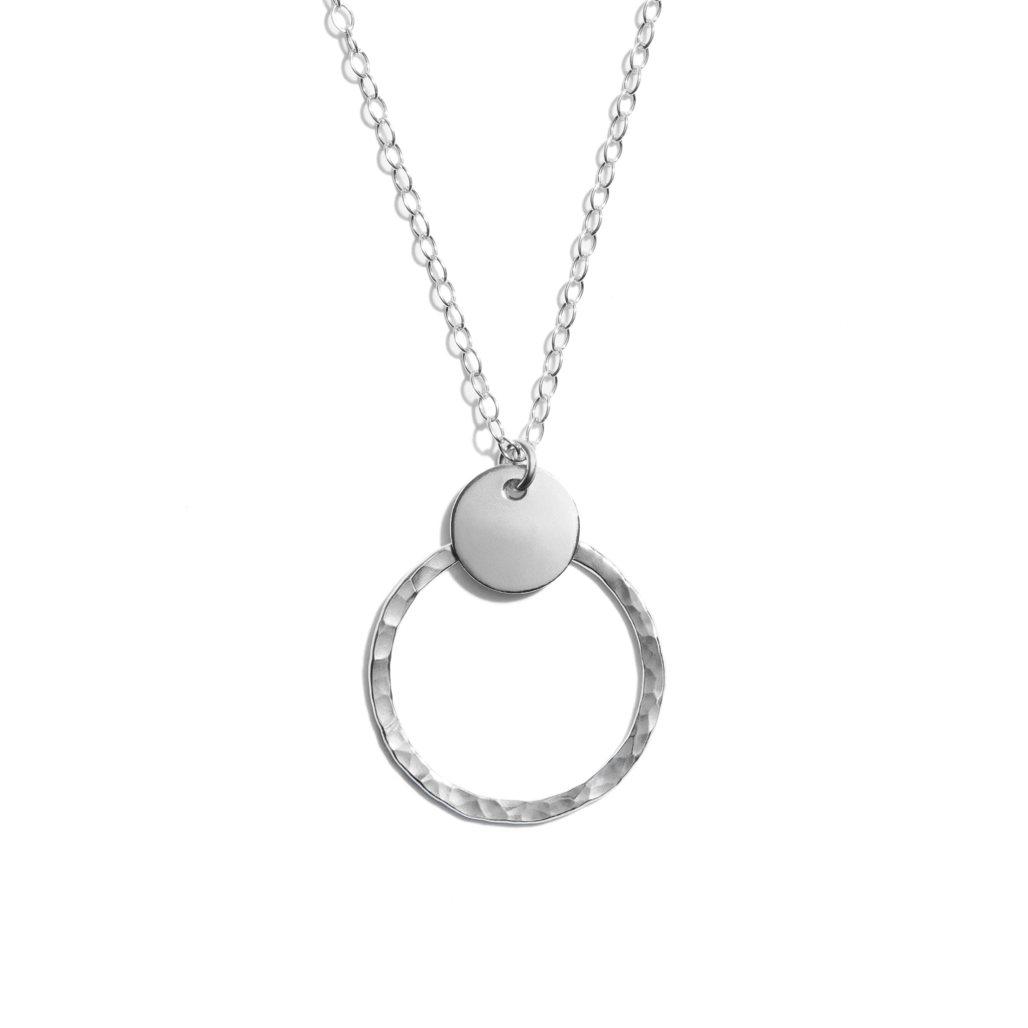 Close-up photo of a duo disk necklace crafted from sterling silver. Perfect for adding elegance to any outfit.